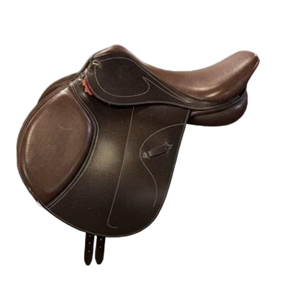 HKM Jumping Saddle Canyon – Dark Brown on a white saddle pad against a wooden floor.