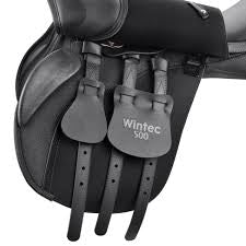 Close-up of a Wintec saddle with leather tags on a dark background